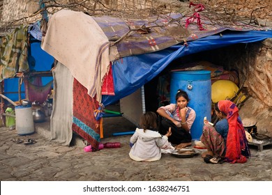 JAIPUR, INDIA - NOVEMBER 09, 2019: Homeless Young People Cooking Evening Meal Next To Improvised Shack Along Street On November 09, 2019 In Jaipur, Rajasthan, India.