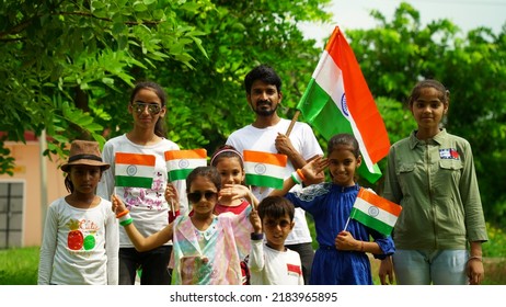 Jaipur, Rajasthan, India - July 2022: Indian Girl Child Holding Indian Flag. Cute Little Indian Girl Holding, Waving Or Running With Tricolour Near A Lake With Greenery In The Background, Celebrating 