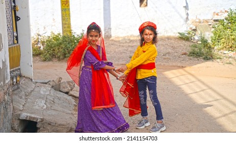 Jaipur, Rajasthan, India, Mar 2022 :  Rajasthani girls dancing before worship to an idol of Isar-Gaura as Lord Shiva and Goddess Parvati on Gangaur festival
