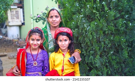 Jaipur, Rajasthan, India, Mar 2022 :  Rajasthani girls before worship to an idol of Isar-Gaura as Lord Shiva and Goddess Parvati on Gangaur festival