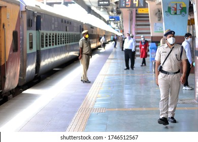 Jaipur,Rajasthan,India_May-2020. Corona Warrior Cops At Work At Jaipur Railway Station,India. Masked Cop Wearing Gadgets Of Mass Communication.Cops Helping The Movement Of Migrant Workers.