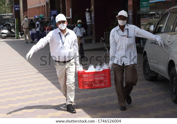 Jaipur,Rajasthan,India_May-2020. Two Corona warriors at\
work in Jaipur,India. Corona warriors doing work amid risk of\
Covid-19 pandemic. Helping the needy ones. Carrying food items for\
distribution.\
