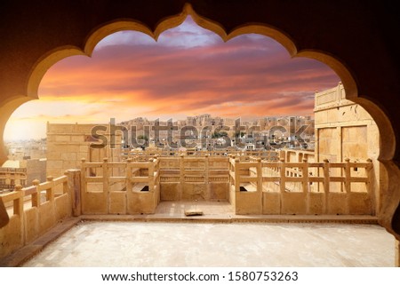 Jaisalmer fort at Purple sunset framing with arch silhouette at sandstone desert city in Rajasthan, India