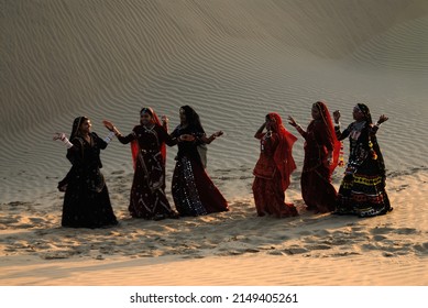 Jaisalmer Rajasthan India Asia Oct. 09 2006 Blurred image Rajasthani girls in traditional outfits dancing traditional folk dance in sand dunes