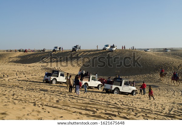 JAISALMER, RAJASTHAN, INDIA- DECEMBER\
2019: Desert Jeep Safari on the sand dunes. Jeep safaris in the\
Thar desert has become very popular in last few years.\
