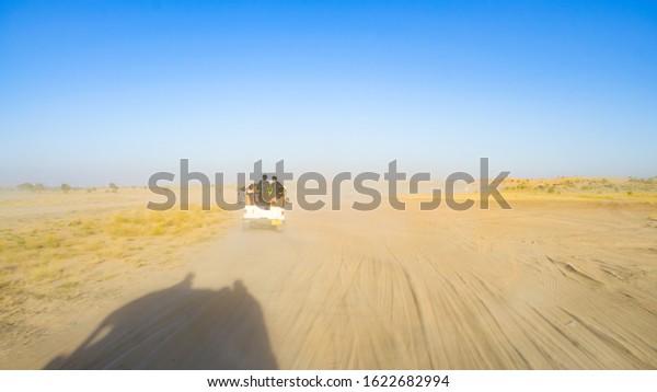 JAISALMER, RAJASTHAN, INDIA- DECEMBER\
2019: Desert Jeep Safari on the sand dunes. Jeep safaris in the\
Thar desert has become very popular in last few\
years.