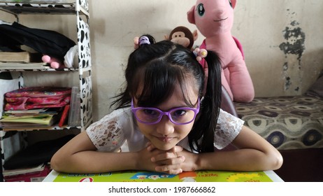 Jakarta 8 June 2021- Little Girl With Purple Glasses Looking Ahead