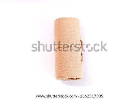 Jakarta, Indoenesia - August 21, 2023 :   A medical equipment of brown elastic bandage on isolated white background. Banage usually used for compressing the leg and arm 