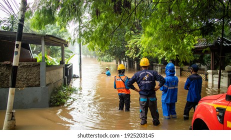 Jakarta, Indonesia (02-21-2021): Rescue Workers Standing In Front Of The Flood That Hit Housing In The City Of Jakarta