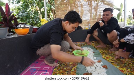 Jakarta, Indonesia -10 December 2021: Asian Men Preparing Food For A Shared Meal (Bancakan), Bancakan Tradition Is Eating Together In One Container Which Is Usually Done In Java