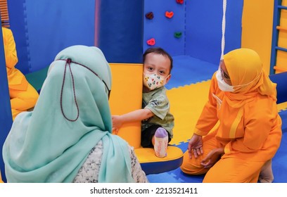 Jakarta, Indonesia 12th 2022 : Child Occupational Therapy Session. Male Children Doing Playful Exercises With His Therapist.