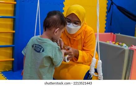 Jakarta, Indonesia 12th 2022 : Child Occupational Therapy Session. Male Children Doing Playful Exercises With His Therapist.