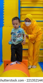 Jakarta, Indonesia 12th 2022 : Child Occupational Therapy Session. Male Children Doing Playful Exercises With His Therapist.