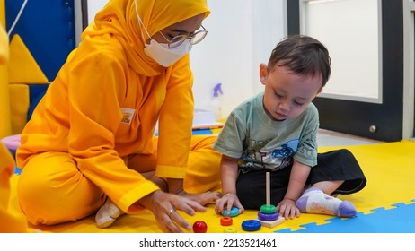 Jakarta, Indonesia 12th 2022 : Child Occupational Therapy Session. Male Children Doing Playful Exercises With His Therapist.