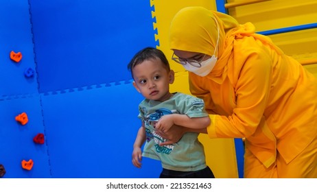 Jakarta, Indonesia 12th 2022 : Child Occupational Therapy Session. Male Children Doing Playful Exercises With His Therapist.