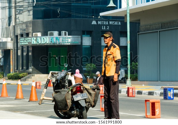 Jakarta, Indonesia - 13 October 2019: \
parking officer in orange uniform in Blok M Square\
