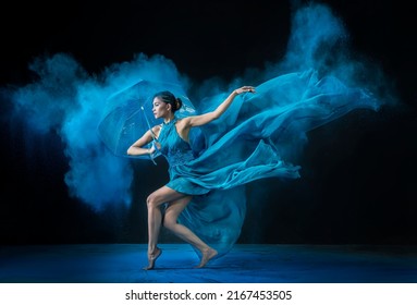 Jakarta, Indonesia- 15 May 2022: Beautiful ballerina is dancing with colourful powder and nice dress