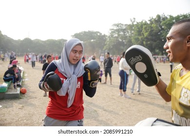 Jakarta, Indonesia - 20.09.2018 A trainer is teaching mixed martial art to children and woman.