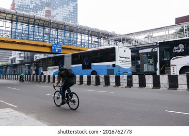 
Jakarta, Indonesia - 22 July 2021,

A Man Cycling Through The Harmoni Exchange Busway Shelter, Jakarta Pusat