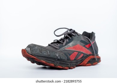 Jakarta, Indonesia, 28-06-2022, Pair Of Old Reebok Shoes On Isolated White Background, Broken Grey Shoe, Old Sneakers, Sport Footwear Sneaker With Broken Sole.