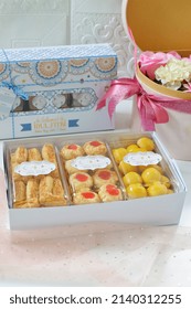 Jakarta, Indonesia 29 March 2022 : Selective focus of Hampers gift on Assorted Indonesian Cookies for Eid al Fitr. Served beautiful hampers with Nastar, snow white, kaastengels and thumbprint cookies.