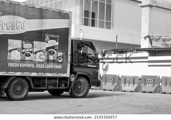 Jakarta, Indonesia -\
april 1 2022: truck box transporting goods and there is an\
advertising poster on the\
box