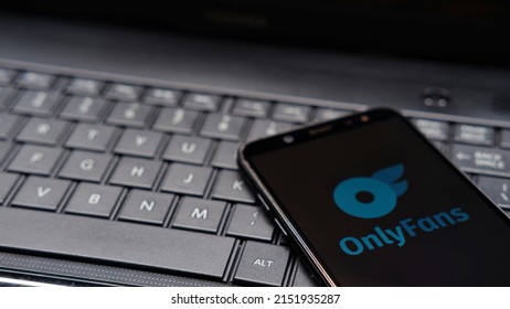 Jakarta, Indonesia - April 29, 2022: OnlyFans logo and symbol on smartphone with keyboard background. OnlyFans is an internet content subscription service which is mostly filled with mature content 