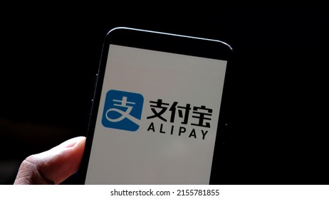 Jakarta, Indonesia - April 29, 2022: AliPay logo display on smartphone with keyboard background
