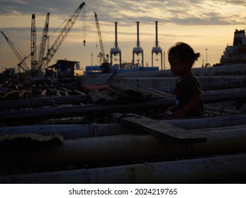 Jakarta, Indonesia - August 12, 2021: Silhoutte Of Children At Cilincing, North Jakarta.