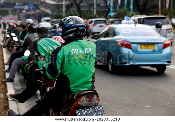 Jakarta,\
Indonesia.\
August 18, 2018.\
\
A row of Gojek, motorbike taxi\
drivers based on online digital applications are waiting for\
passengers on the side of the main Jakarta\
road.
