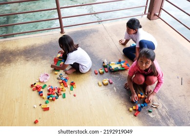 Jakarta, Indonesia - August 23 2022: The Child Is Playing Lego Outside The Yard Of The House 