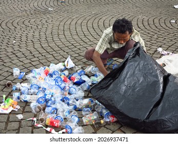 Jakarta, Indonesia - Dec 8 2013: Man Picking Up Trash By Hand