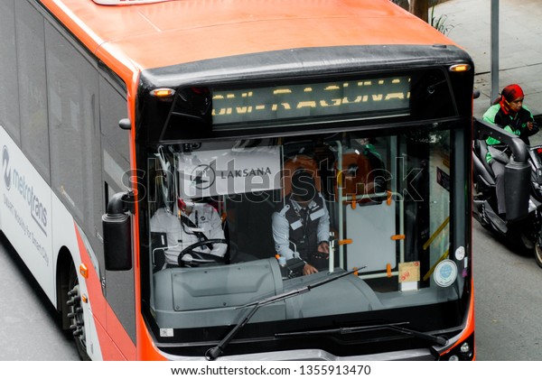 Jakarta, Indonesia - February\
13, 2019: Metrotrans bus in Jakarta, Smart Mobility for Smart\
City.