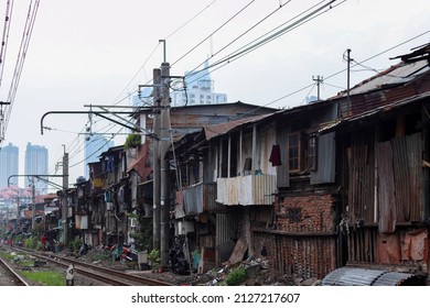 jakarta, Indonesia - February 19, 2022. rundown houses made of old zinc on the edge of jakarta's electric railway tracks