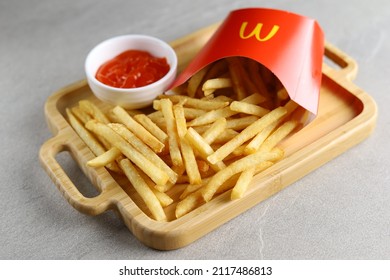 Jakarta, Indonesia, February 2, 2022: McDonald French Fries In Paper Cup Or Package Isolated On White Background. McDonald Company Is The Most Popular Market Leader In USA