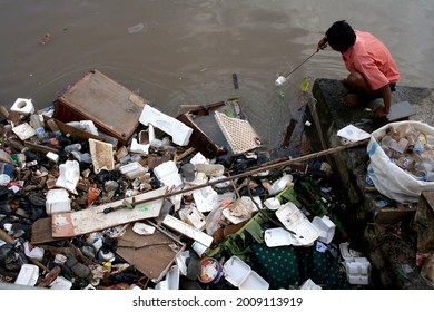 Jakarta, Indonesia. 
February 5, 2007.  
Trash picker sort out items that can still be resold. There are still many residents of Jakarta who throw garbage in the river that could cause flood. 