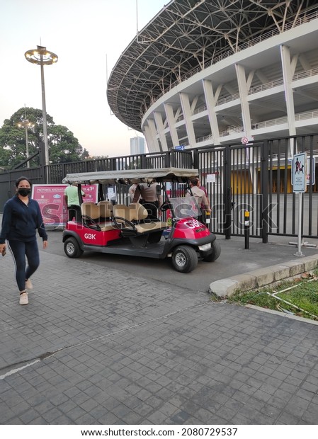 JAKARTA, INDONESIA\
- JANUARY 2021: not focused, noisy and grainy texture of red\
electric vehicle to patrolling around the sports Stadium Gelora\
Bung Karno (GBK) Central Jakarta\
City