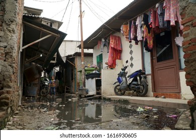 JAKARTA, INDONESIA - JANUARY 8, 2020: Aftermath Of Flood Causes Dirty Water Puddle In Front Of A Small House On A Dirty Street At Slum Area In North Jakarta, Indonesia.