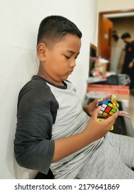 Jakarta, Indonesia - July 18, 2022: Kid Playing Rubik's Cube. Rubik's Cube Invented By A Hungarian Architect Erno Rubik In 1974.