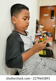 Jakarta, Indonesia - July 18, 2022: Kid Playing Rubik's Cube. Rubik's Cube Invented By A Hungarian Architect Erno Rubik In 1974.