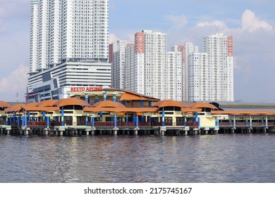 Jakarta, Indonesia - July 2, 2022. Floating Restaurant Building Above Sea Level With Apartment Building Background