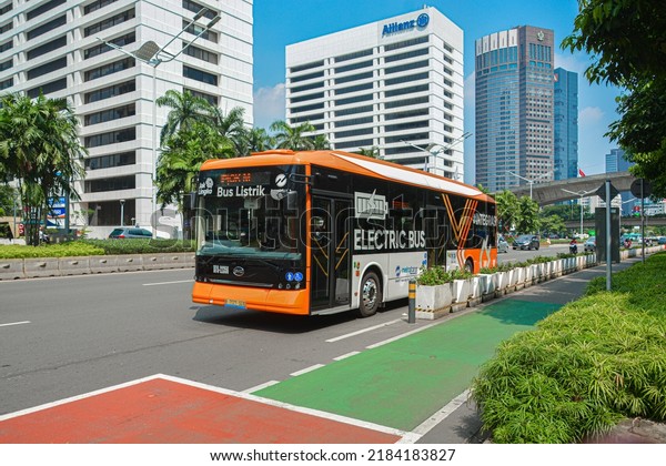 \
Jakarta, Indonesia - June 19, 2022:\
The Trans Jakarta Electric Bus passes the JPO Phinisi Karet\
Sudirman bus stop, Central Jakarta jl jendral sudirman\
jakarta