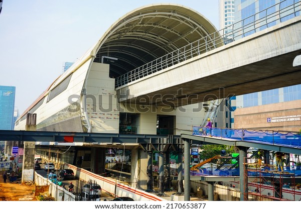 Jakarta, Indonesia - June, 2022 : \
The\
situation on the Rasuna Said highway which has a lot of vehicles\
passing and the construction of the LRT (Light Rail Transit)\
railway station and\
flyover.
