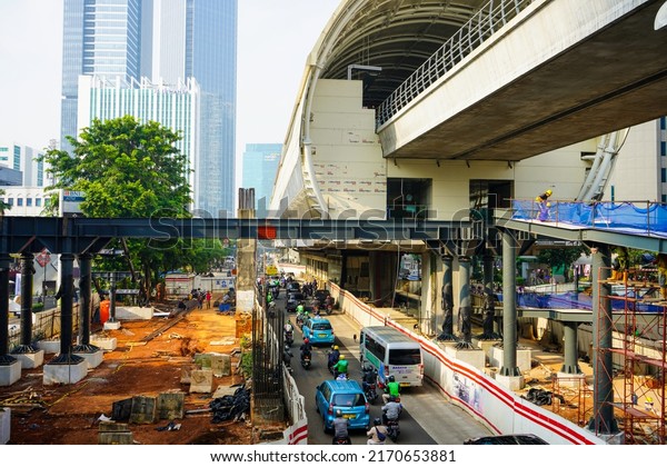 Jakarta, Indonesia - June, 2022 : \
The\
situation on the Rasuna Said highway which has a lot of vehicles\
passing and the construction of the LRT (Light Rail Transit)\
railway station and\
flyover.