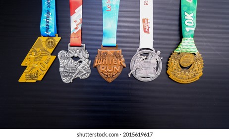 Jakarta, Indonesia - June 27, 2021: Number Of Running Medals In Various Colors On A Black Background.