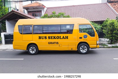 Jakarta, Indonesia - June 9 2021: A Yellow Public School Minibus Belongs To Jakarta's Transportation Department Being Parked In Front Of House In Central Jakarta, Indonesia.