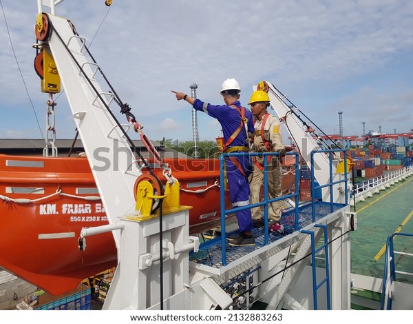 jakarta,
indonesia - March 7, 2022 : Routine maintenance on the ship carried
out by the crew and all parts of the ship, one of which is lifeboat
maintenance used during an emergency. 
