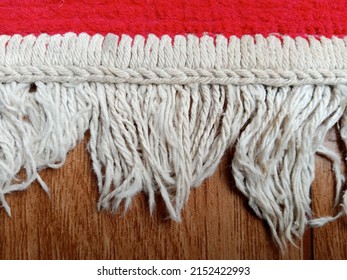 Jakarta, Indonesia. May 2, 2022. Rug Edge With Dangling Knitting Threads On Brown Background