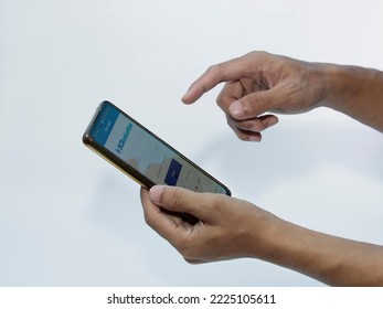 Jakarta, Indonesia - November 08, 2022: A Man Uses The BCA Securities Application On His Smartphone, A Popular Stock Trading Company In Indonesia To Buy Stocks Easily Without Coming To The Stock Excha