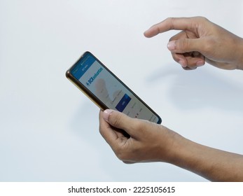 Jakarta, Indonesia - November 08, 2022: A Man Uses The BCA Securities Application On His Smartphone, A Popular Stock Trading Company In Indonesia To Buy Stocks Easily Without Coming To The Stock Excha